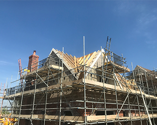 residential property under construction and surrounded by scaffolding