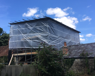 domestic property with a tarpaulin sheet covering the construction work underneath