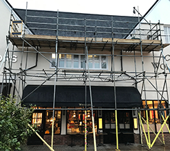 shop front with scaffolding above the entrance