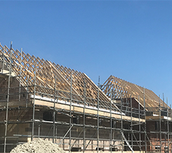 wooden roof frame being constructed on construction site