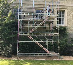 scaffolding structure set up outside of traditional house