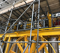 yellow industrial scaffolding complemented by steel scaffolding beams