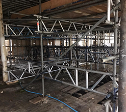 interior exposed scaffolding beams fastened by scaffolding fixtures